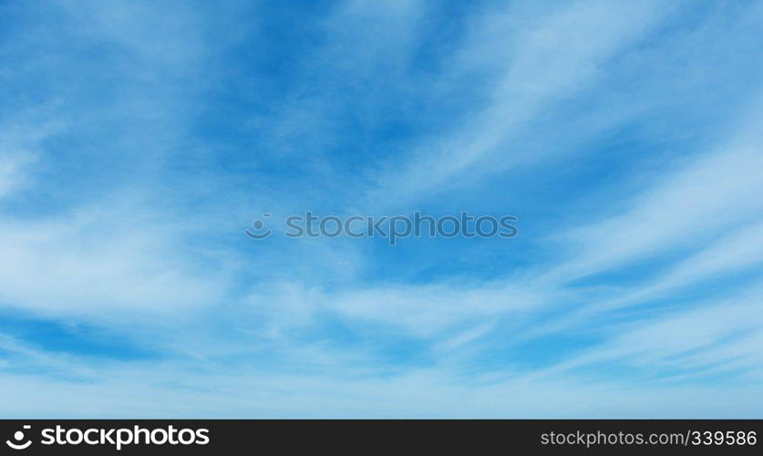 White cirrus fuzzy clouds in the blue azure sky. Summer good weather background.