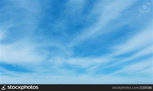 White cirrus fuzzy clouds in the blue azure sky. Summer good weather background.