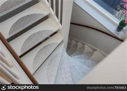 White classic staircase in ariel view, new design close-up. White classic staircase in ariel view, new design