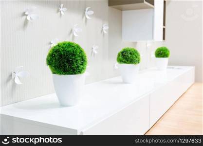 White clean interior with grass in vase
