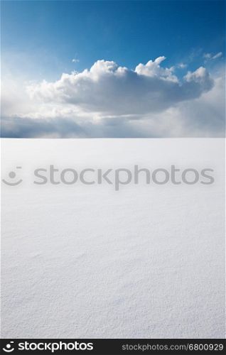 White clear surface of snow till flat horizon and beautiful cloudscape; copy space