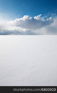 White clear surface of snow till flat horizon and beautiful cloudscape; copy space