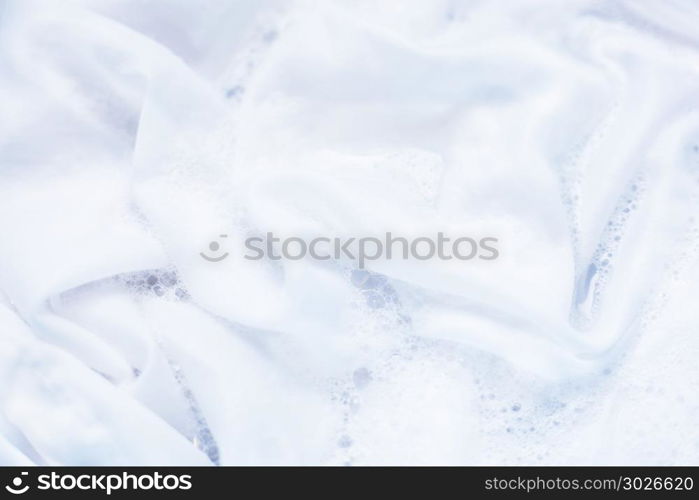 White clothes soak, before washing.. White clothes soak in water with washing powder, before washing.