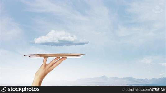 White cloud on tray. Human hand holding metal tray with cloud