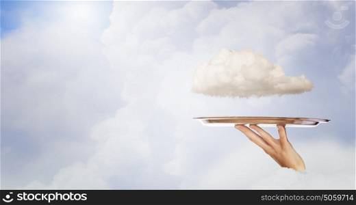 White cloud on tray. Human hand holding metal tray with cloud
