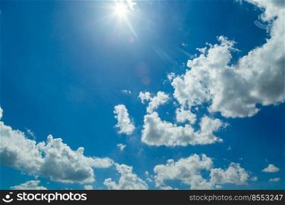white clouds and blue sky with sunlight