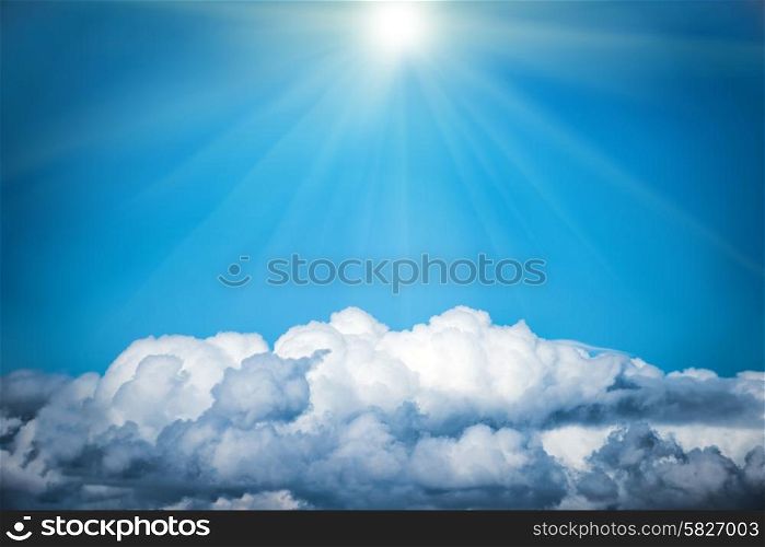 White clouds and bright sun on the blue sky. Nature background