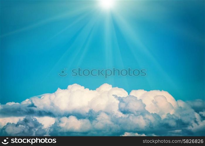 White clouds and bright sun on the blue sky. Nature background, instagram colorized