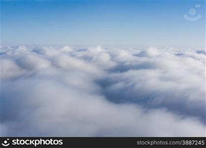 White clouds. Beautiful blue sky sea, a view from an aeroplane above the clouds