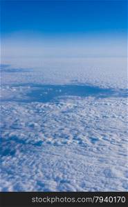 White clouds. Beautiful blue sky sea, a view from an aeroplane above the clouds