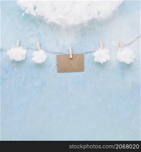 white clouds brown card hang string with clothespins
