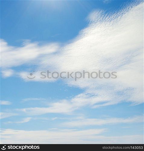 White clouds illuminated by bright sun. Copy space