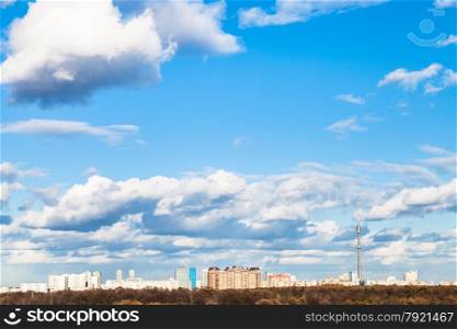white clouds in blue spring sky over city, Moscow