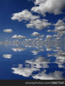 white clouds in the blue sky, with water reflection