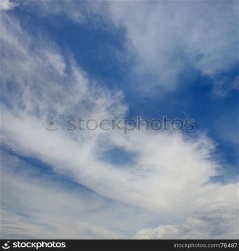 White clouds on a background of dark blue sky.