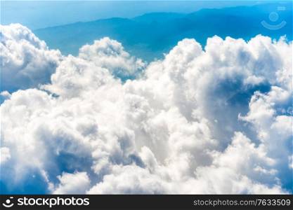 White clouds on blue sky with above aerial view from a plane, nature blue sky background