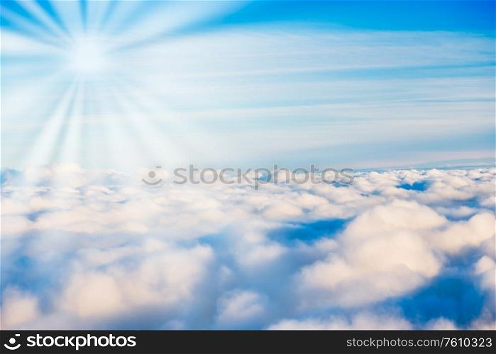 White clouds on blue sky with sun rays as cloudscape nature background