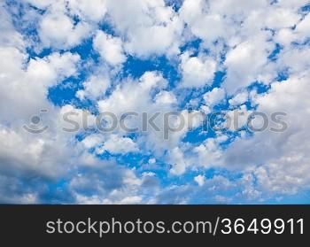 White clouds over a deep blue sky