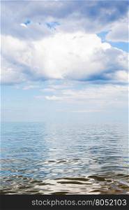 white clouds over calm water of Azov Sea, Temryuk bay, Golubitskaya resort, Taman peninsula, Kuban, Russia