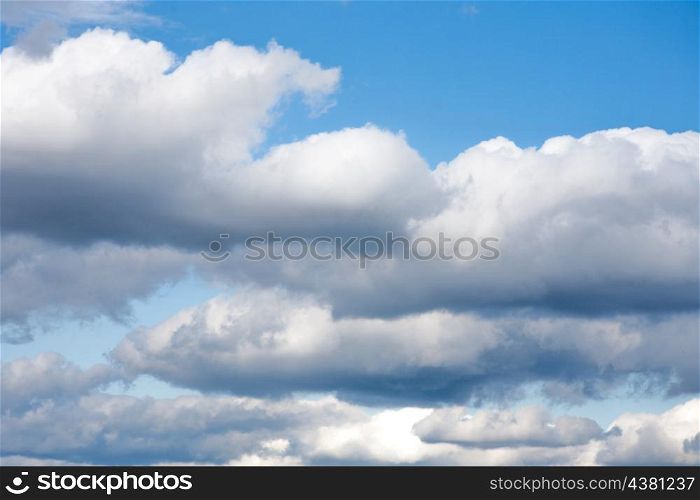 white clouds over deep blue sky