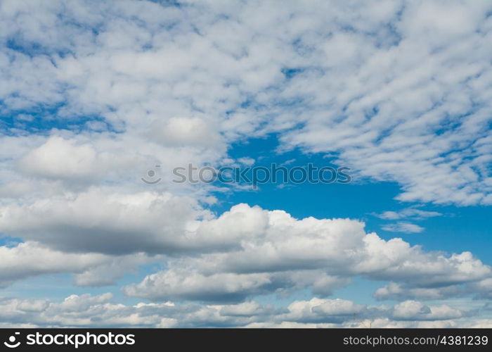 white clouds over deep blue sky