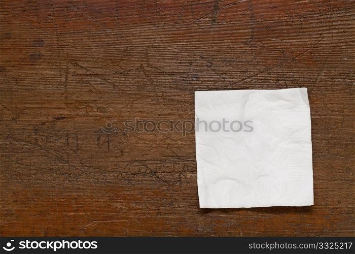 white cocktail napkin on old scratched grunge wood table