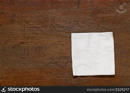 white cocktail napkin on old scratched grunge wood table