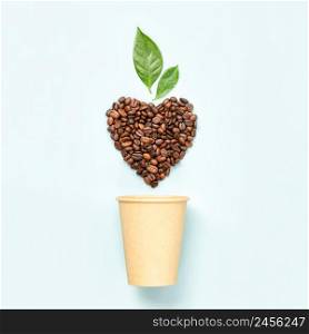 White coffee cup and coffee beans in shape of heart on white background, flat lay. White coffee cup and coffee beans in shape of heart on white background