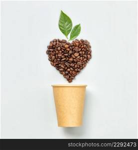 White coffee cup and coffee beans in shape of heart on white background, top view. White coffee cup and coffee beans in shape of heart on white background, flat lay