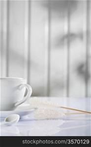 white coffee cup and spoon with sugar stick