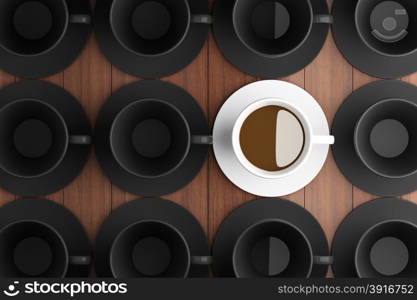 White coffee cup in the middle of a black coffee cup.