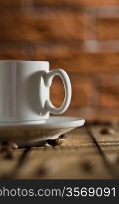 white coffee cup on a background of a brick wall