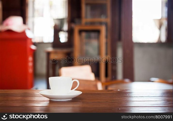 White coffee cup on wooden table in coffee shop
