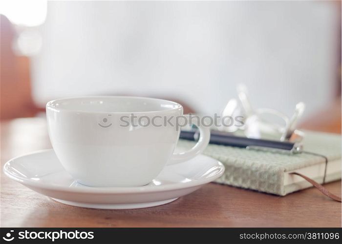 White coffee cup on wooden table, stock photo