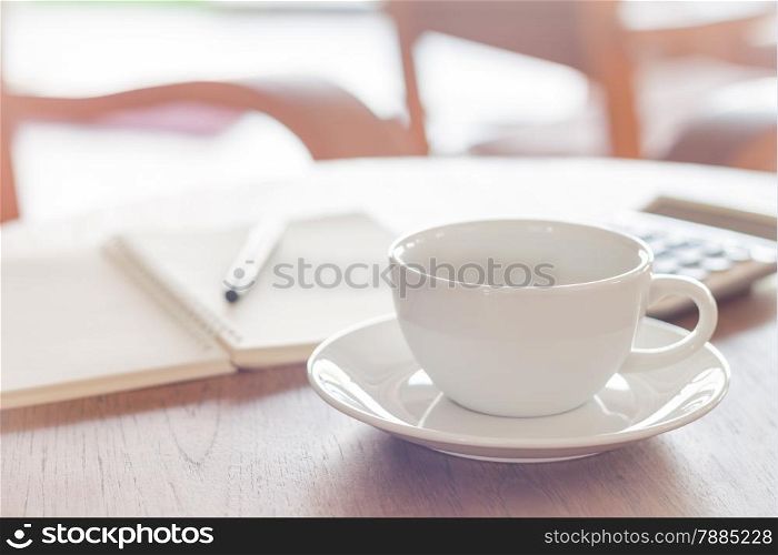 White coffee cup on wooden table, stock photo