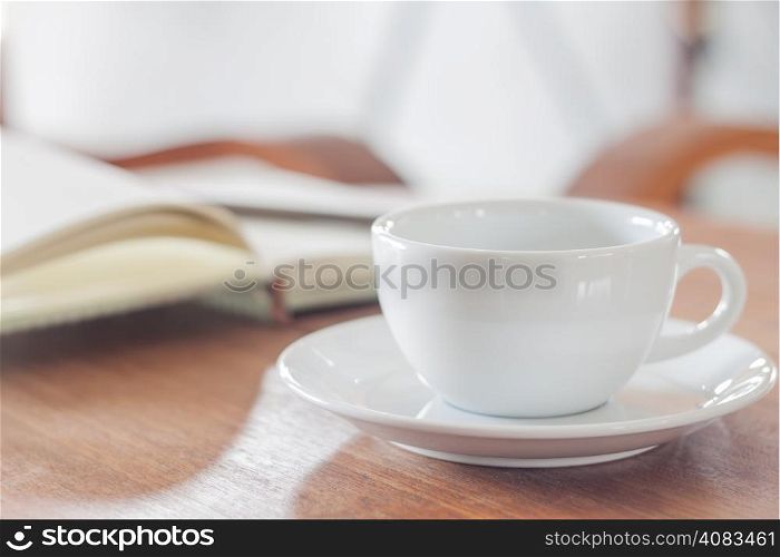 White coffee cup with notebook, stock photo