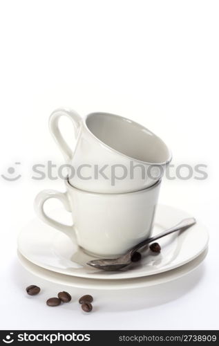 White coffee cups with saucers. Isolated on white