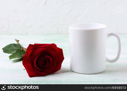 White coffee mug mockup with dark red rose. Empty mug mock up for design presentation.. White coffee mug mockup with dark red rose