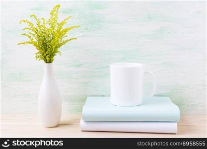 White coffee mug mockup with ornamental green flowering grass. Empty mug mock up for design promotion. . White coffee mug mockup with ornamental green flowering grass