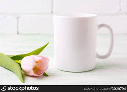 White coffee mug mockup with tender pink tulip flower. Empty mug mock up for design promotion. . White coffee mug mockup with pink tulip
