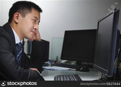White-collar worker sitting in front of computer in office