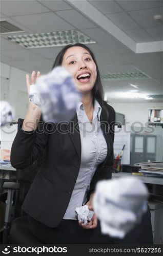 White-collar worker throwing paper in office