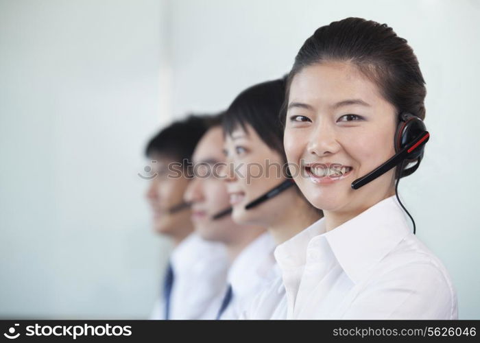 White Collar Workers in a row with headsets