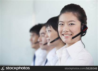 White Collar Workers in a row with headsets