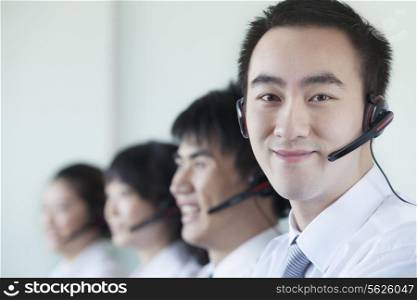 White Collar workers in a row with headsets