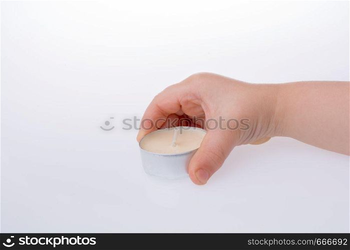 White color small Candle in hand on a white background