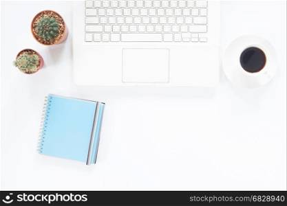 White computer laptop with coffee cup, notebook and cactus on white desk, Workspace concept