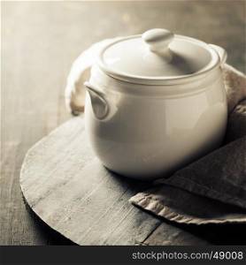White cooking pot on rustic background
