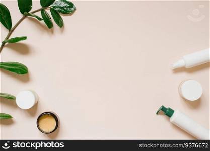 White cosmetic jar and a bottle of cream with a top view of the leaves of plants, a mock-up of the product design. Natural organic cosmetics