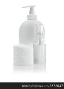 white cosmetical bottles and pads